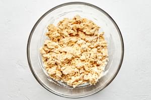 pierogi dough in a glass bowl made with flour, water, salt and oil