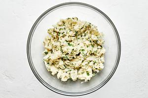pierogi filling made with mashed potatoes, salt, pepper, olive oil and mint in a glass bowl