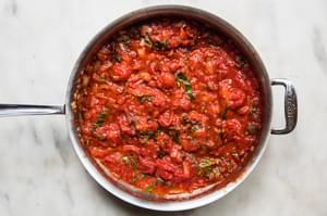 olive oil, onions, garlic, basil, oregano and bouillon stored together, simmering in a pan