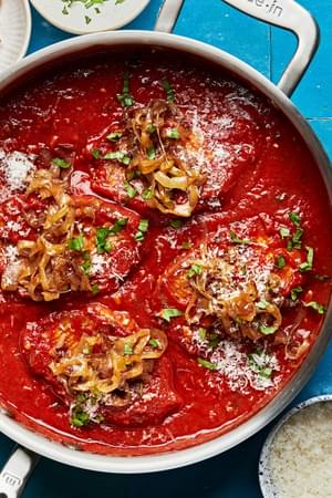 4 pork chops braised in tomato sauce topped with basil, parmesan and caramelized onions