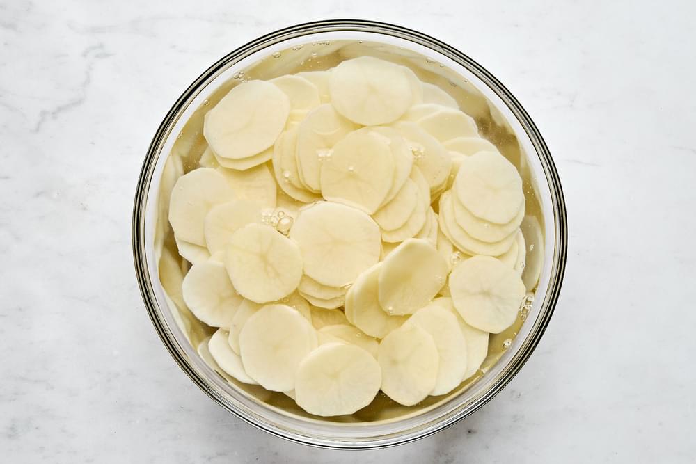 Thinly sliced potatoes soaked in water