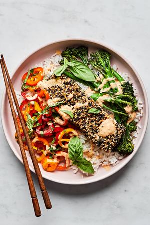 Sesame crusted salmon and broccolini on top of rice served with pepper salad and drizzled with chili tahini sauce.