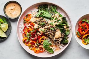 Sesame crusted salmon and broccolini on top of rice served with pepper salad and drizzled with chili tahini sauce.