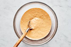 tahini, lime juice, grated ginger, salt, garlic chili paste, and water mixed together in a glass bowl