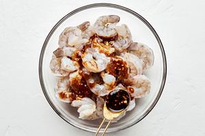 shrimp being tossed with oyster sauce, soy sauce, Shaoxing, brown sugar, chili sauce, garlic, ginger & salt