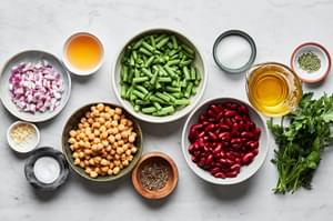 green beans, kidney & garbanzo beans, red onion, parsley, garlic, apple cider vinegar, sugar olive oil & spices in prep bowls