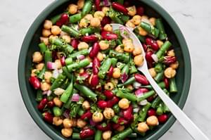 3 bean salad in a serving bowl with a serving spoon