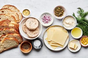 tuna, mayo, capers, onions, lemon zest, lemon juice, dill, mustard, cheese, spices, butter and bread in prep bowls