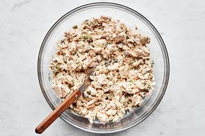 tuna, mayonnaise, capers, onions, lemon zest, lemon juice, dill, mustard, salt, and pepper stirred together in a glass bowl