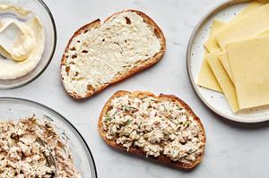 2 slices of bread spread with mayo and butter and filled with tuna tuna, mayo, capers, onions, mustard and spices