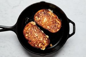 a tuna melt sandwich being grilled in a skillet