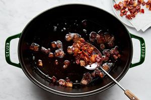 chopped bacon being cooked in a dutch oven