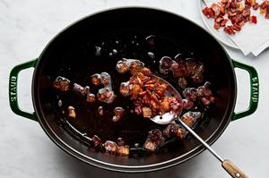chopped bacon being cooked in a dutch oven