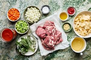 pork, onion, carrots, celery, tomato sauce, wine, thyme, basil, parsley and sage in prep bowls to make pork ragu