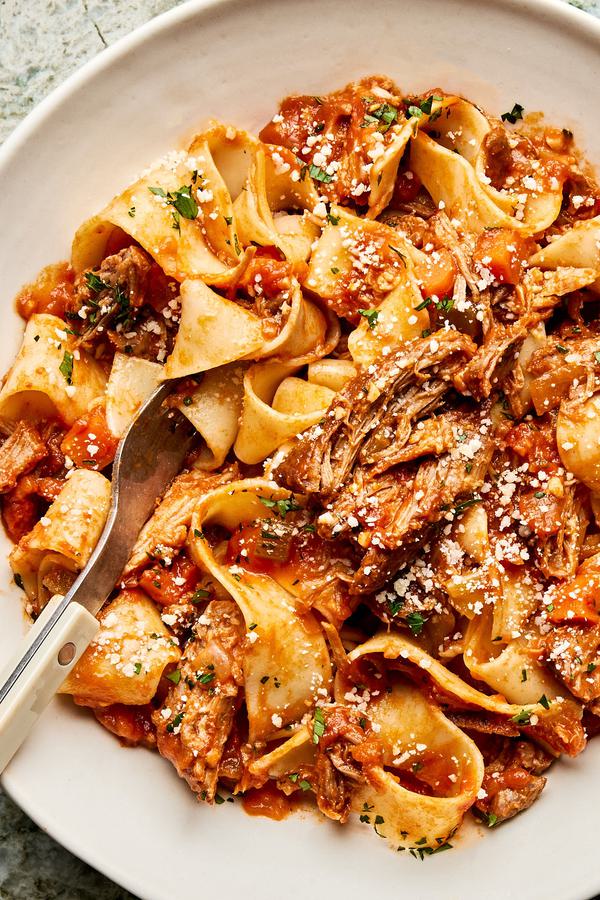 homemade braised pork ragu served over cooked pappardelle noodles