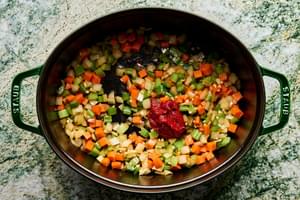 onion, carrots, celery and tomato paste cooking in a pot