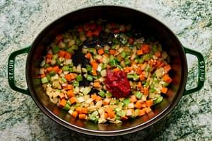 onion, carrots, celery and tomato paste cooking in a pot