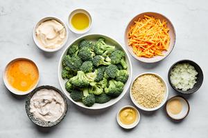 broccoli, cream of mushroom soup, mayo, dijon, onion, egg, cheese and panko in prep bowls for broccoli casserole