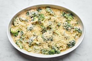 broccoli, cheese, cream of mushroom soup, mayonnaise, mustard, grated onion mixed in a baking dish covered in panko