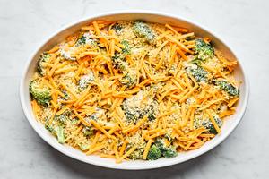 broccoli casserole in a baking dish made with cream of mushroom soup, mayonnaise and dijon topped with cheese