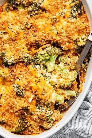 broccoli casserole in a baking dish made with cream of mushroom soup, mayonnaise and dijon topped with cheese and panko
