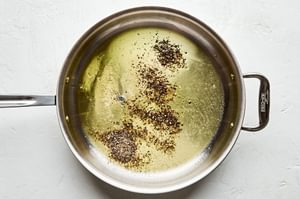 olive oil, butter and pepper being combined in a skillet