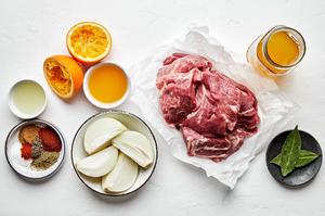 pork shoulder, orange & lime juice, onion, chicken stock and spices in prep bowls to make carnitas