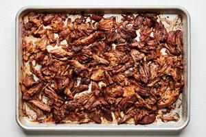 crispy carnitas on a baking sheet after just being broiled in the oven