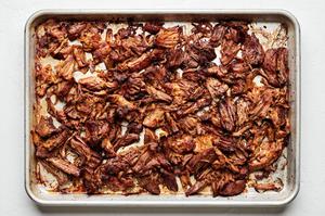 crispy carnitas on a baking sheet after just being broiled in the oven