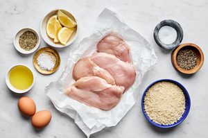chicken breast, panko, salt, pepper, italian seasoning, eggs, vegetable oil and lemon wedges in prep bowls