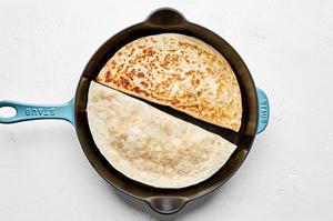 chicken quesadillas being cooked in a skillet
