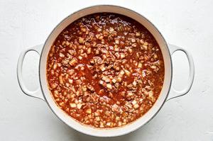 ground beef, stock, onion, garlic, tomatoes, Worcestershire and spices being cooked in a soup pot