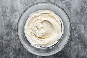 cream cheese, mayo and sour cream stirred together in a bowl to make homemade crab dip, the best party appetizer