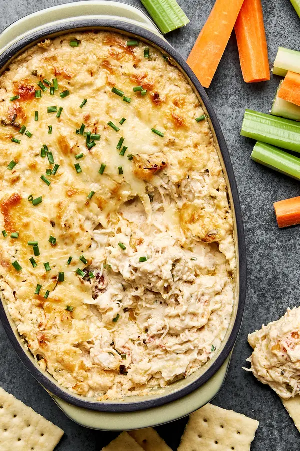 Hot crab dip with old bay seasoning served with crackers and raw vegetables. A great party appetizer.
