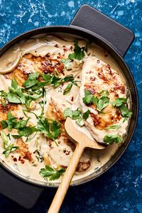 creamy coconut lime chicken in a skillet made with coconut milk, lime juice, onion garlic, salt & brown sugar