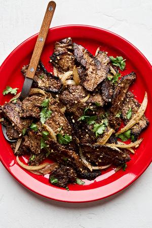 Cumin Beef Stir Fry on a plate topped with fresh cilantro