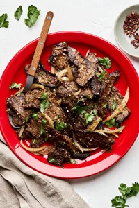 Cumin Beef Stir Fry on a plate topped with fresh cilantro