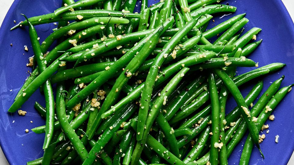a plate of garlic green beans made with olive oil, garlic, salt and pepper