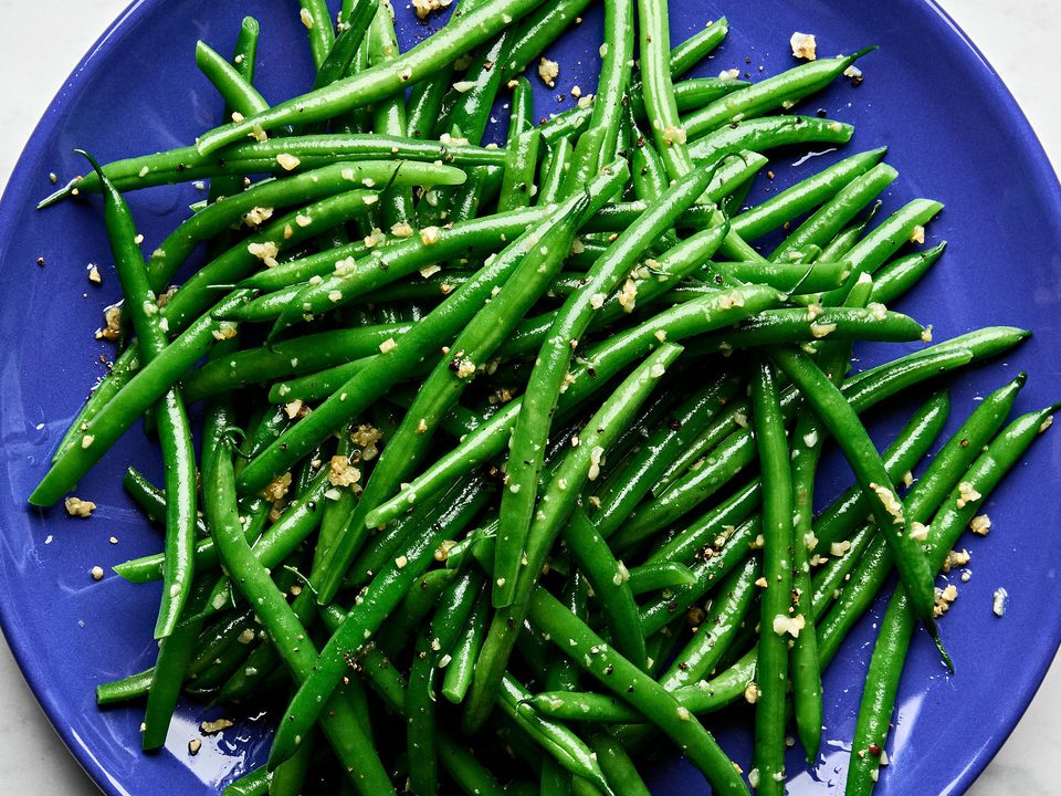 a plate of garlic green beans made with olive oil, garlic, salt and pepper