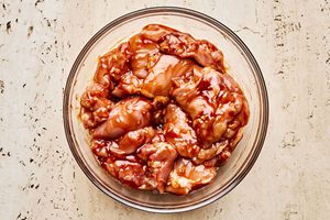 raw chicken marinating in sweet and smoky huli huli sauce