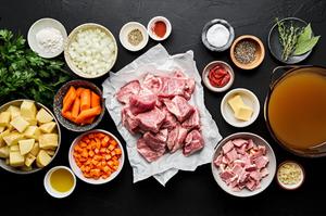 pork, potatoes, carrots, onion, carrots, bacon, spices, tomato paste, chicken stock, butter, flour and parsley in prep bowls