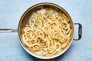 caramelized onions being cooked in a skillet
