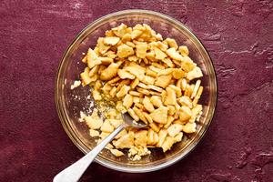 ritz crackers being crushed in a bowl