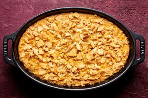 scalloped corn casserole made with creamed corn, butter, cream, eggs, sugar and spices topped with crushed crackers