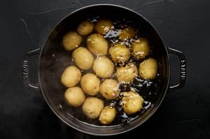 baby gold potatoes boiling in a pot of water