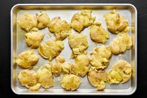 boiled baby gold potatoes smashed on a baking sheet