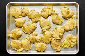 boiled baby gold potatoes smashed on a baking sheet