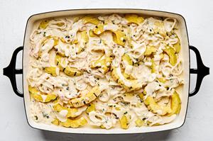 homemade cream sauce poured over roasted squash in a baking dish