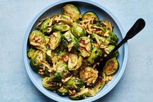 a bowl of homemade Sweet-and-Sour Roasted Brussels Sprouts made with almonds and shallots