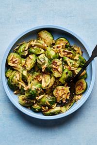 a bowl of homemade Sweet-and-Sour Roasted Brussels Sprouts made with almonds and shallots